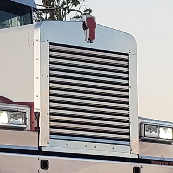 Kenworth W900L Aftermarket Grill Surround - Angled View On Truck